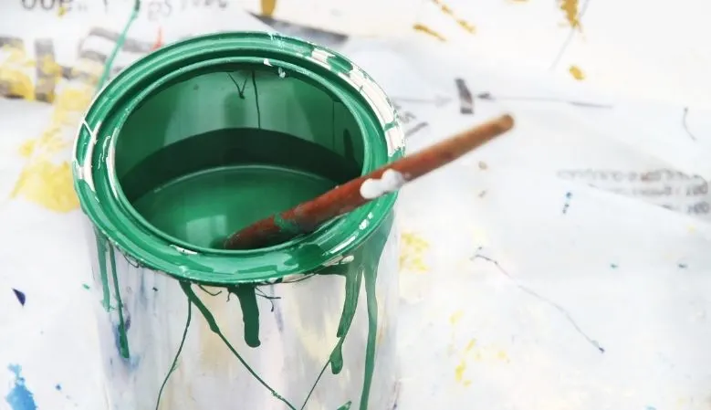 oil paint can and brush