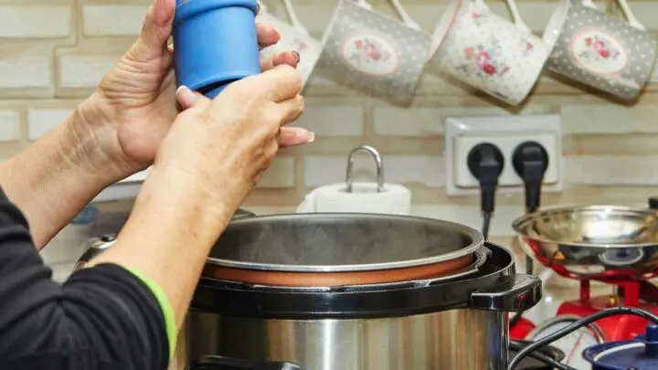 Woman cooking with enough distance from the wall socket