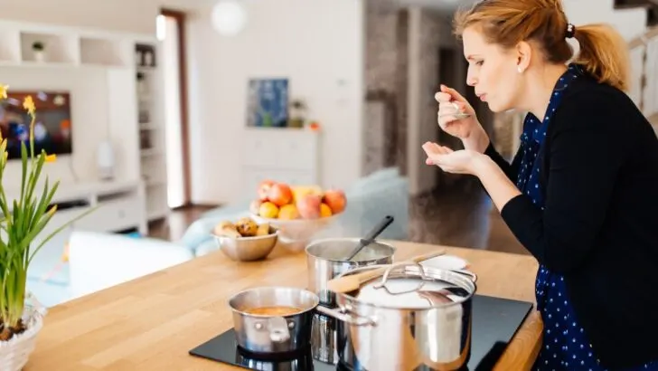 Woman tasting soup in the kitchen