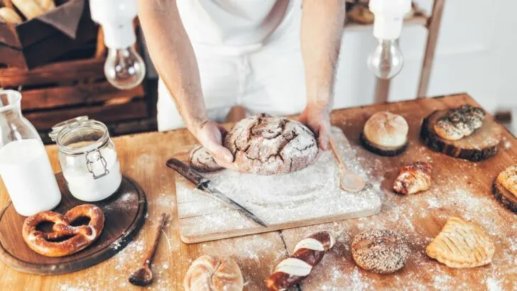 Baker with delicious bread and pastry