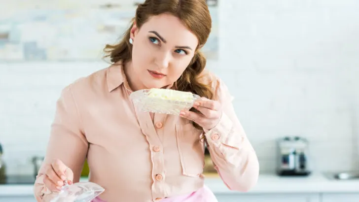 Woman sniffing butter