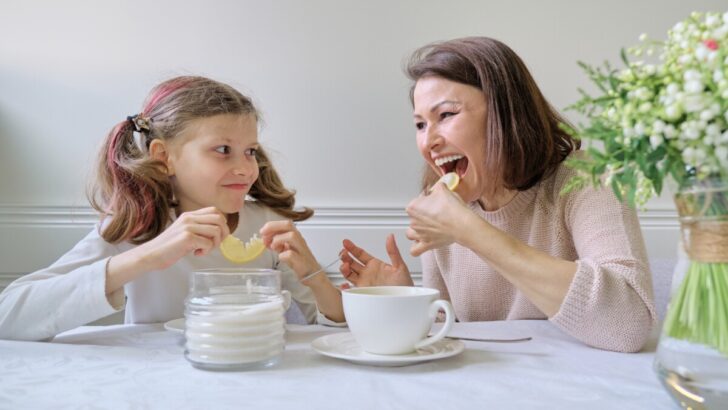 mother and daughter eating lemons