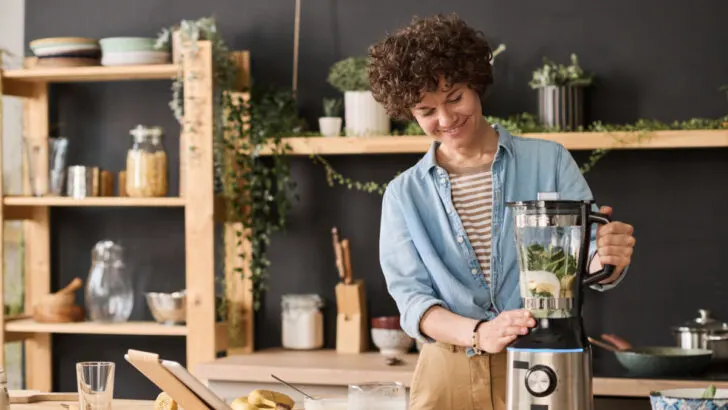 Woman using a blender