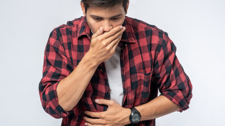 Man with stomache after eating bad chicken