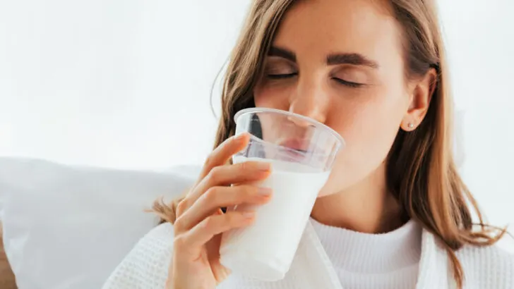 Young woman drinking milk